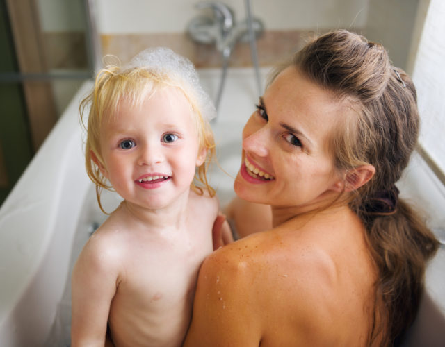 Portrait of mother and baby taking bath