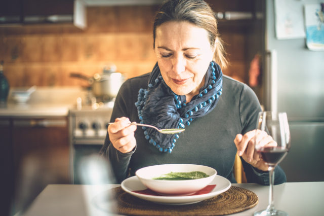 Mature woman eating soup